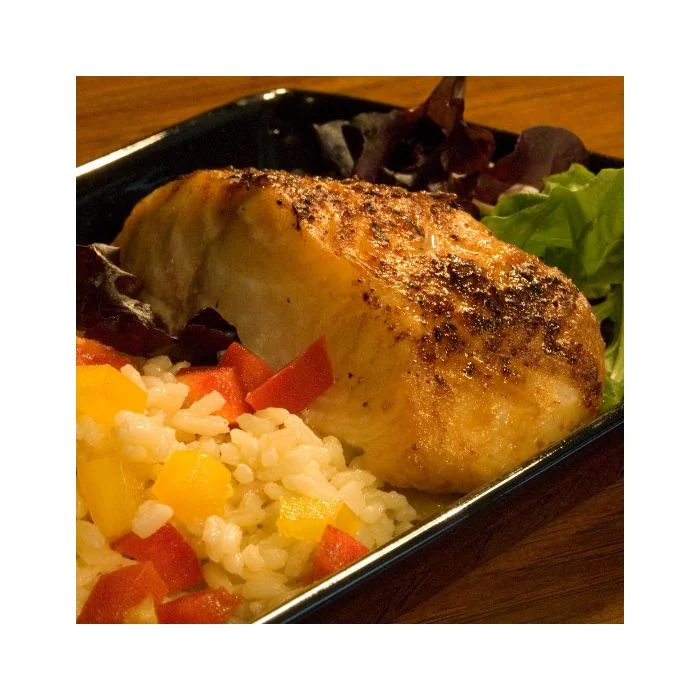 A large sampler of Whitefish, specifically Black Cod, Halibut and Rockfish presented on a dinner plate