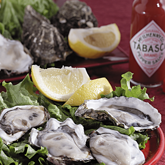 A batch of freshly cleaned oysters in their natural shells, prepared using high pressure cleaning method.