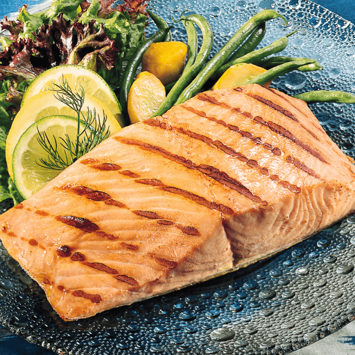 16 pieces of King salmon fillets neatly arranged in a display.