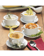 Four different types of soup served in individual bowls, arranged together for a diverse meal option.