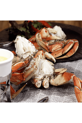 Fresh Dungeness Crab Sections displayed on a clean surface.