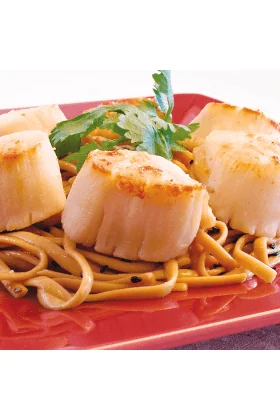 A pile of jumbo sea scallops, fresh and ready to be cooked.